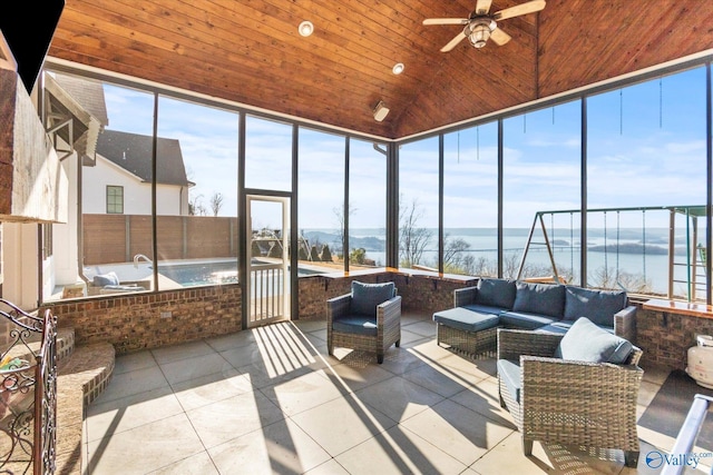 sunroom featuring wood ceiling, lofted ceiling, ceiling fan, and a water view