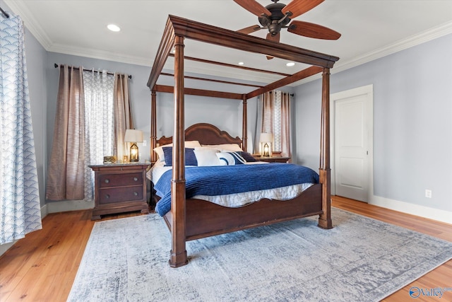 bedroom with recessed lighting, ornamental molding, baseboards, and wood finished floors