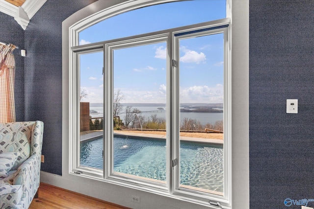 view of swimming pool with a water view