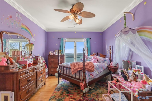 bedroom with ceiling fan, multiple windows, light wood-style floors, and ornamental molding