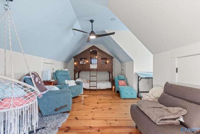 bedroom with ceiling fan, a baseboard radiator, lofted ceiling, and wood finished floors