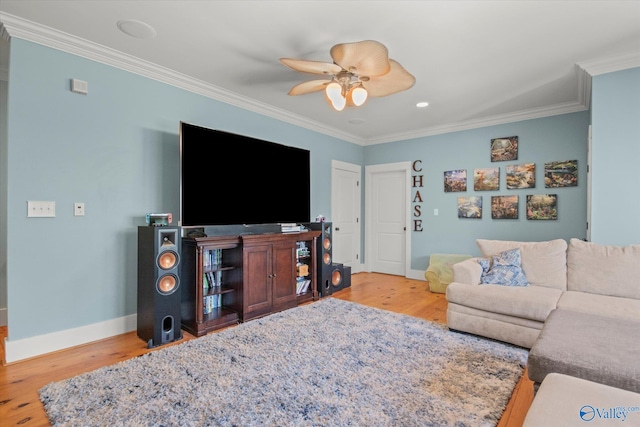 living room with ornamental molding, baseboards, and wood finished floors