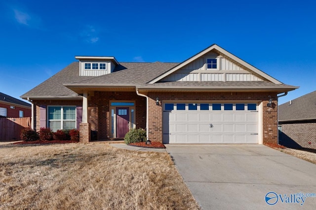 view of front facade with brick siding, concrete driveway, board and batten siding, fence, and a garage