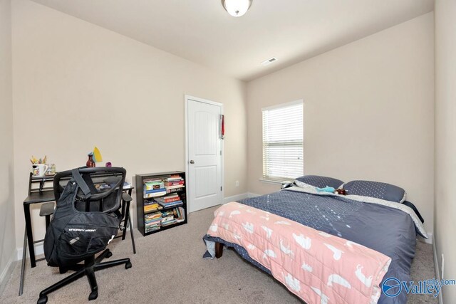 carpeted bedroom with baseboards and visible vents