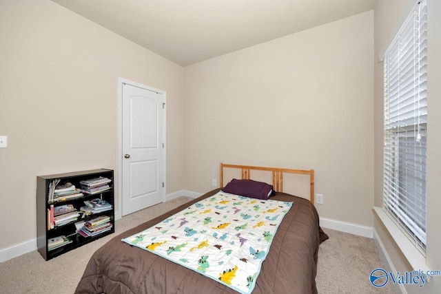 bedroom featuring carpet and baseboards