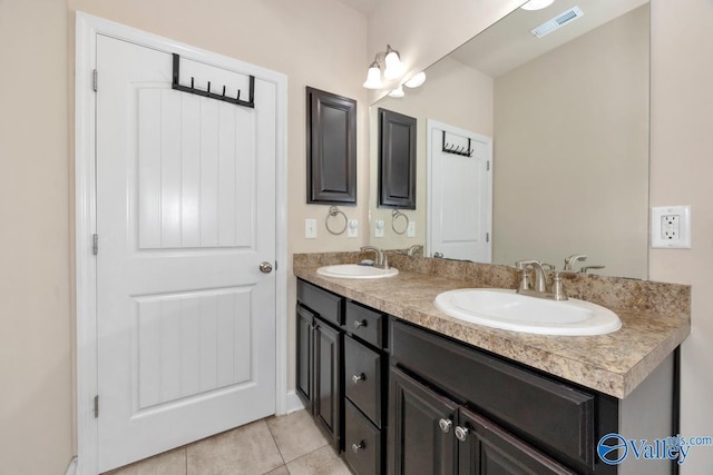 bathroom featuring tile patterned flooring, visible vents, a sink, and double vanity