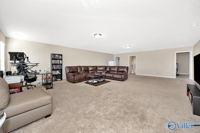 carpeted living room with baseboards