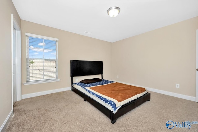 carpeted bedroom featuring baseboards