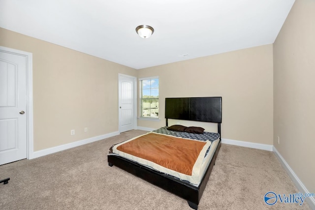 bedroom with baseboards and carpet flooring