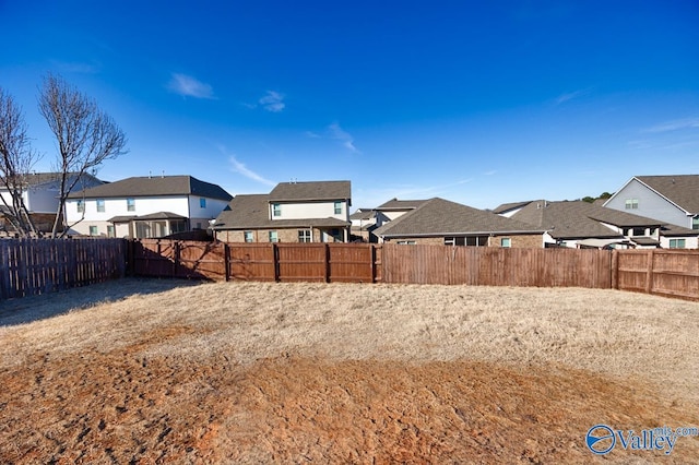 view of yard with a residential view and a fenced backyard