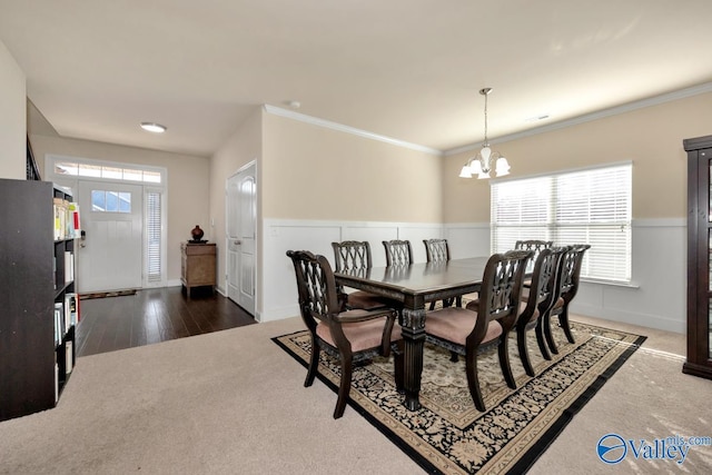 dining room featuring a chandelier, carpet, and a healthy amount of sunlight