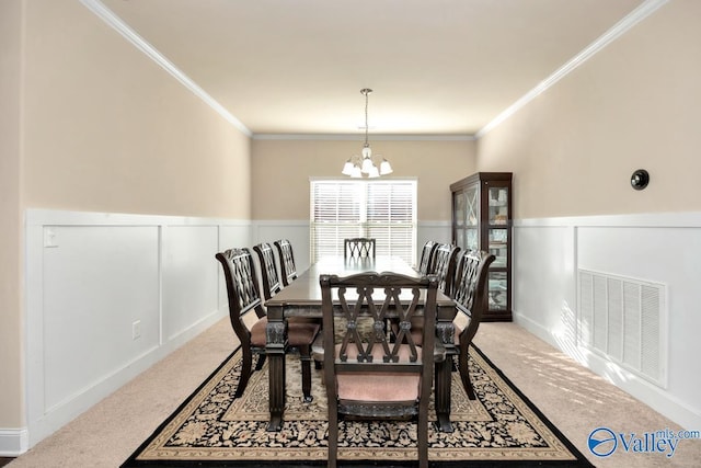 dining space with light carpet, wainscoting, visible vents, and a notable chandelier