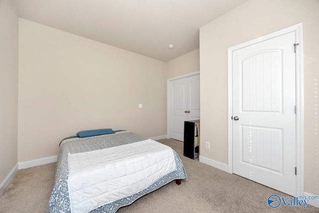 bedroom featuring baseboards and light colored carpet