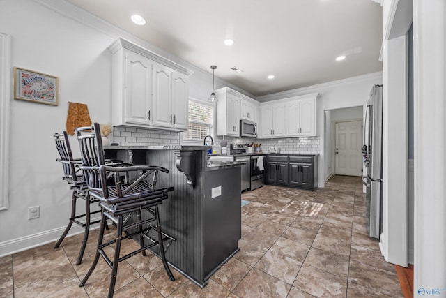 11 Nandina Ln SW, Huntsville, AL 35824 - kitchen with stainless steel appliances, a peninsula, white cabinetry, backsplash, and a kitchen bar