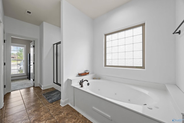 11 Nandina Ln SW, Huntsville, AL 35824 - full bath with a stall shower, a jetted tub, baseboards, and tile patterned flooring