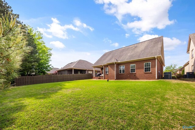 11 Nandina Ln SW, Huntsville, AL 35824 - back of property featuring central AC unit, brick siding, and a shingled roof