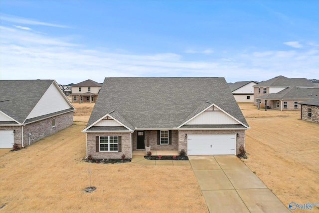 craftsman house with a garage and a front lawn