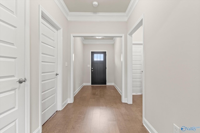 doorway to outside featuring hardwood / wood-style floors and ornamental molding