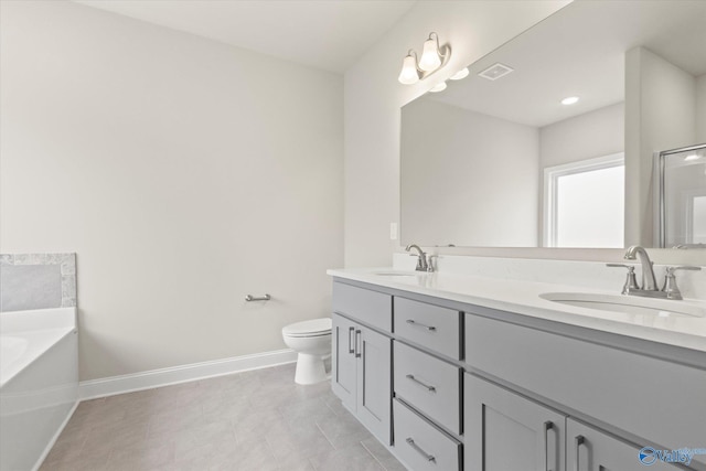 bathroom with tile patterned flooring, vanity, a bath, and toilet