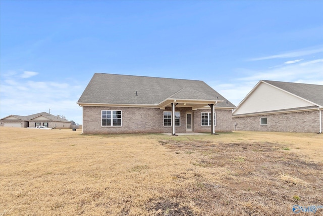 rear view of house with a lawn