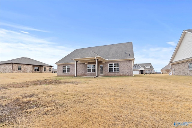 back of house featuring a yard