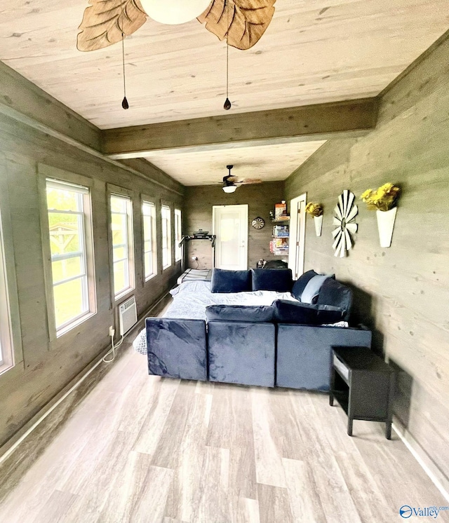 living area with wood ceiling, a ceiling fan, wood finished floors, beamed ceiling, and an AC wall unit