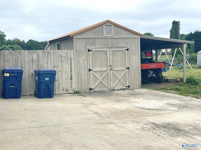 view of shed featuring fence