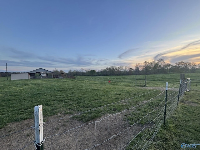 view of yard featuring fence and a rural view