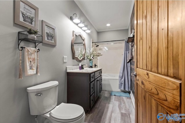 bathroom with wood finished floors, shower / tub combo, vanity, toilet, and ornamental molding