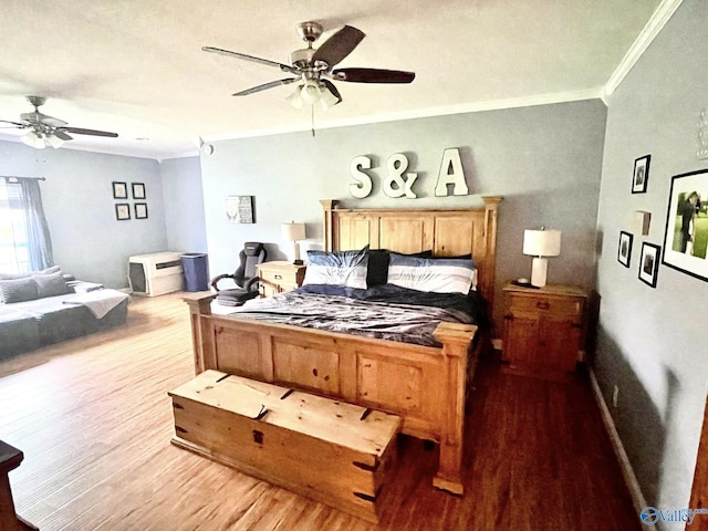 bedroom with a ceiling fan, ornamental molding, and light wood-style floors