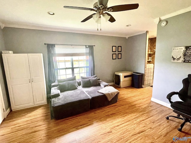 bedroom featuring crown molding, baseboards, a ceiling fan, and light wood finished floors