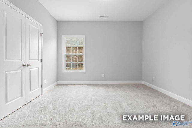 unfurnished bedroom featuring a closet and carpet floors