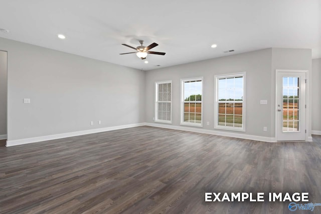 unfurnished room with ceiling fan and dark wood-type flooring