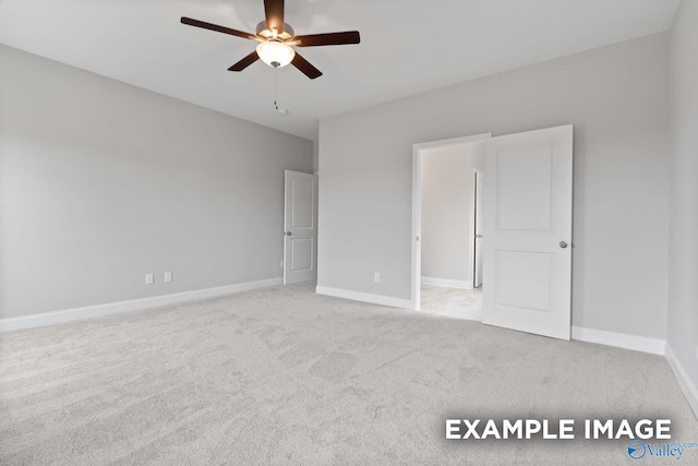 unfurnished bedroom with ceiling fan and light colored carpet