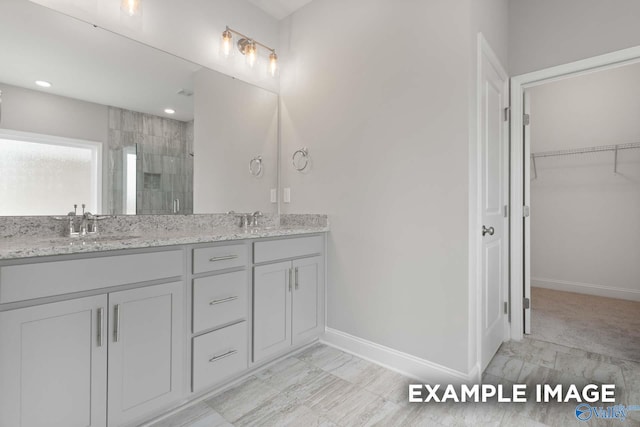 bathroom featuring vanity and a shower with shower door