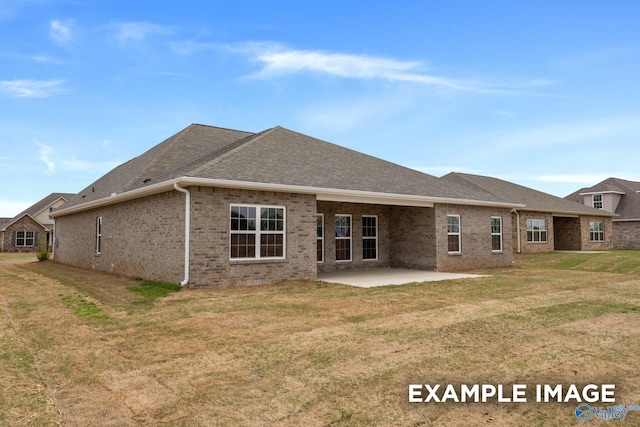 rear view of property with a patio and a lawn