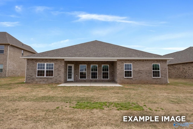 rear view of house featuring a patio and a lawn