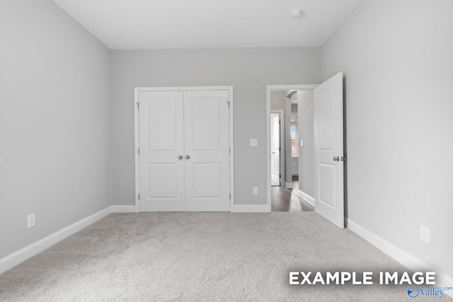 unfurnished bedroom with carpet floors and a closet