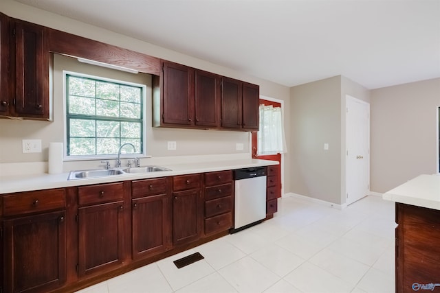 kitchen featuring sink, dishwasher, and light tile patterned floors