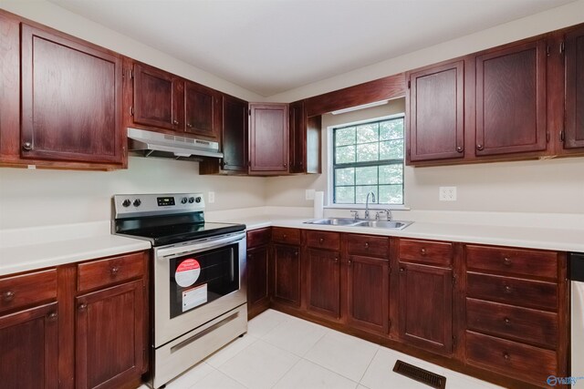 kitchen featuring light tile patterned floors, stainless steel electric range, dishwashing machine, and sink