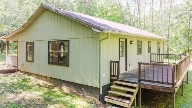 rear view of house featuring a deck