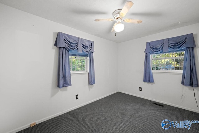 carpeted empty room featuring ceiling fan and a healthy amount of sunlight