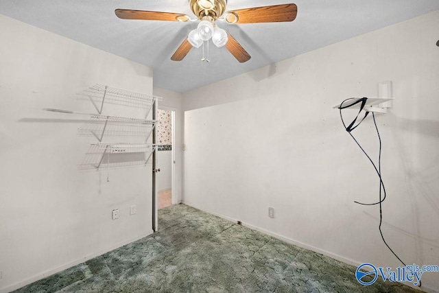 carpeted spare room with ceiling fan