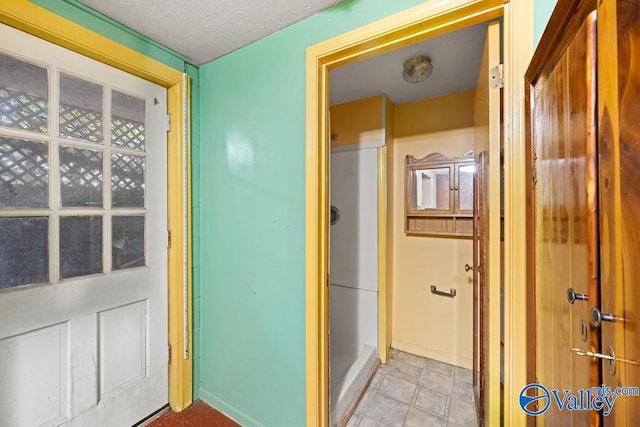 hallway with a textured ceiling