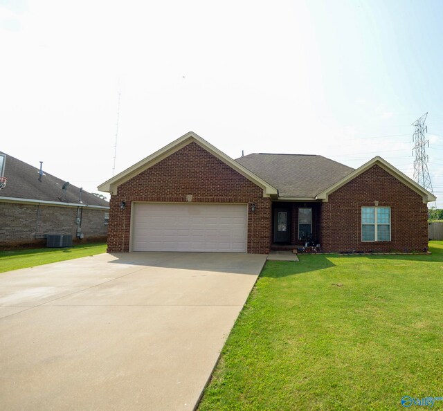 302 Meredith Dr, Muscle Shoals, AL 35661 - single story home featuring brick siding, an attached garage, a front yard, and concrete driveway