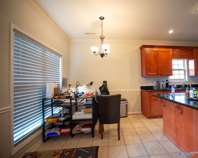 302 Meredith Dr, Muscle Shoals, AL 35661 - kitchen featuring a chandelier, light tile patterned floors, brown cabinetry, crown molding, and pendant lighting