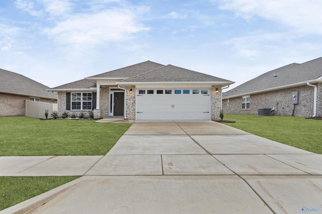 view of front facade featuring a garage, a front yard, concrete driveway, and central air condition unit