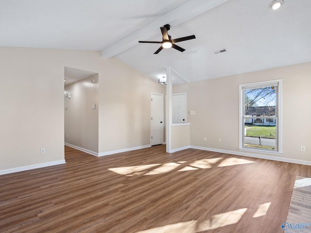 spare room with ceiling fan, hardwood / wood-style floors, and vaulted ceiling with beams