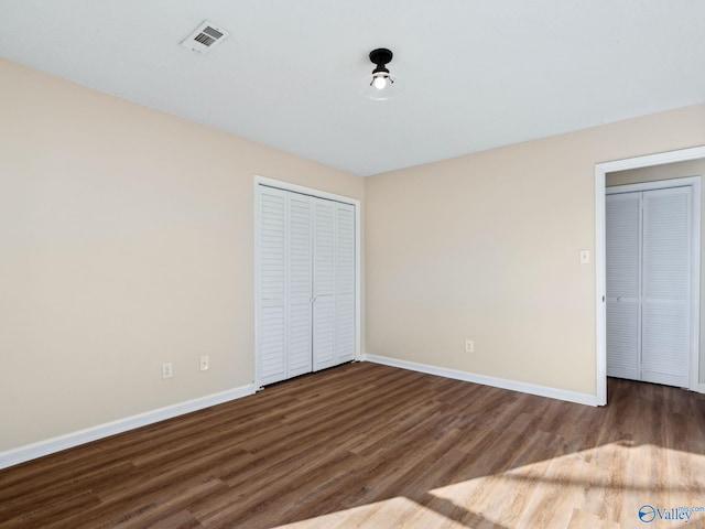 unfurnished bedroom with wood-type flooring and a closet