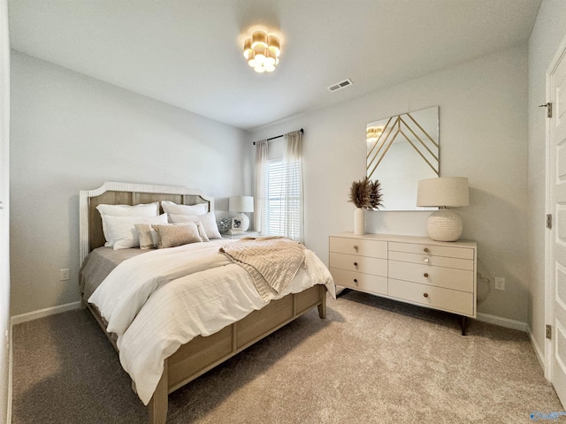 bedroom with visible vents, baseboards, and light colored carpet